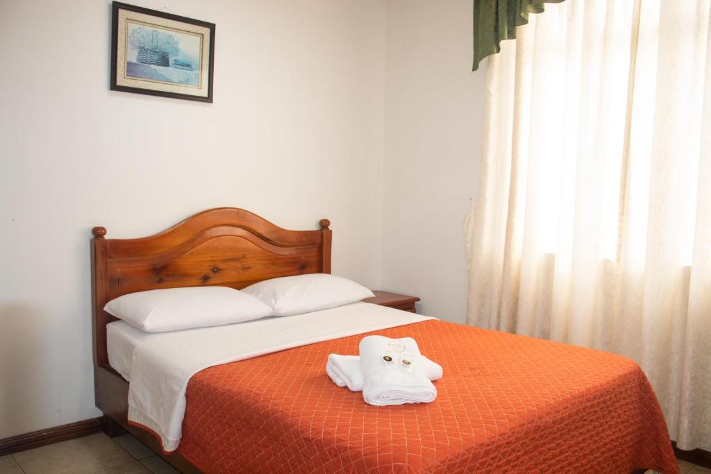 Postel nebo postele na pokoji v ubytování Hotel Colonial