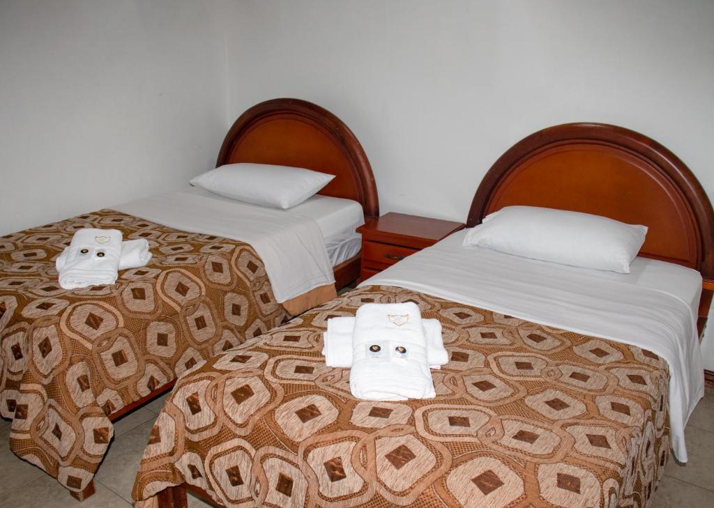 Postel nebo postele na pokoji v ubytování Hotel Colonial