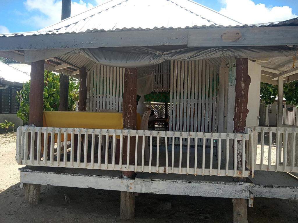 a small house with a porch with a roof at Vacation beach fale in Manase