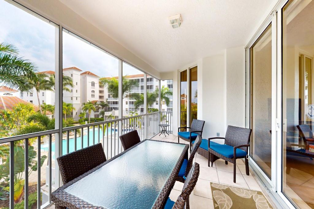 a balcony with a table and chairs on a balcony at Sailor's Rest in Naples