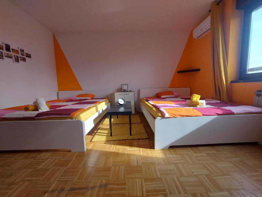 a room with two beds and a tv in it at Zagreb apartment Toni in Zagreb