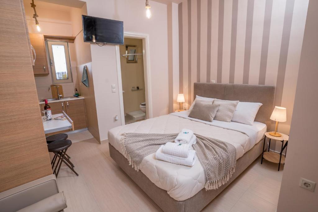 a bedroom with a bed with a towel on it at Comfy and Cosy Studio Kalamata B in Kalamata