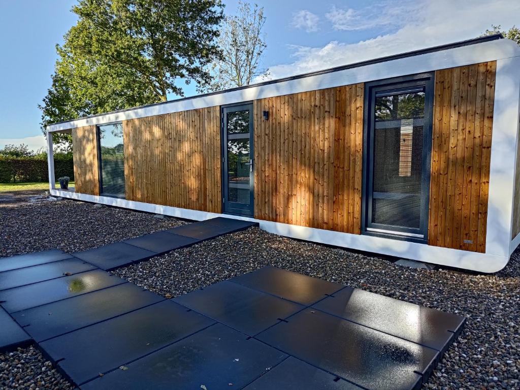 een modern huis met een houten gevel bij Vakantiewoningen Eyveld in Beesel