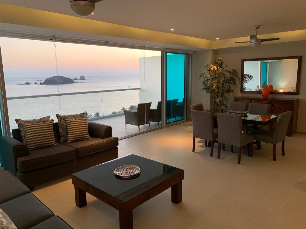 a living room with a couch and a table at Peninsula 12 D in Ixtapa