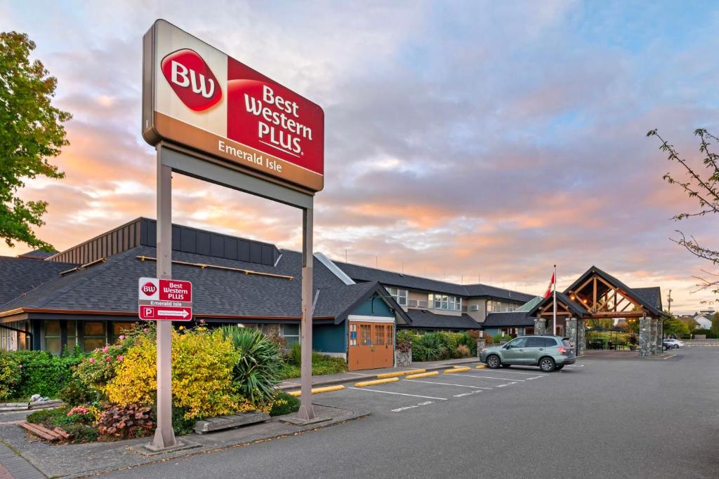 a sign for a best western plus in a parking lot at Best Western Plus Emerald Isle Hotel in Sidney