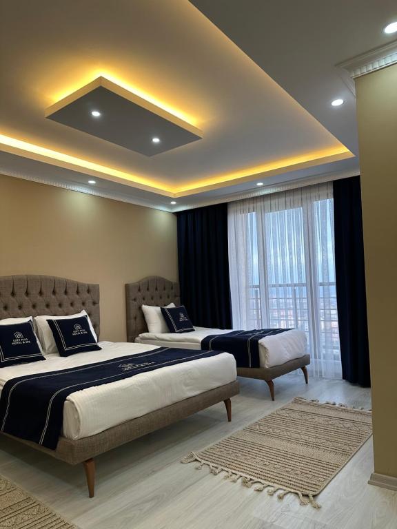 a bedroom with two beds and a ceiling at Loft House in Arnavutköy