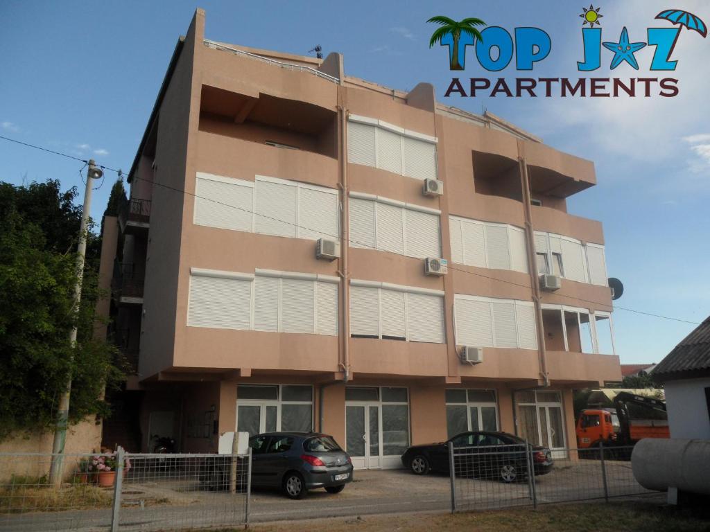 a building with cars parked in front of it at Top Jaz Apartments in Budva
