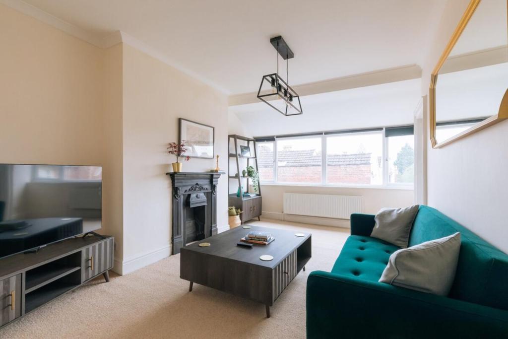 a living room with a couch and a table and a tv at Bright & Delightful 2BD Flat Clifton Down Bristol in Bristol