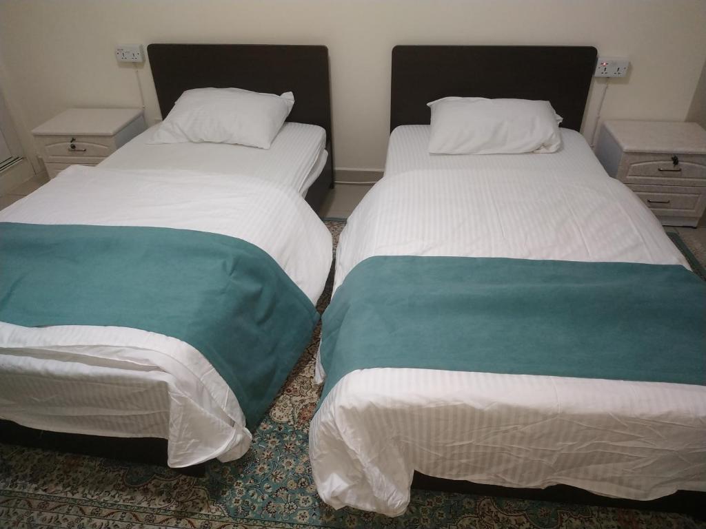 two beds sitting next to each other in a room at Ruby Star Hostel Dubai F 4 R 2-3 in Dubai