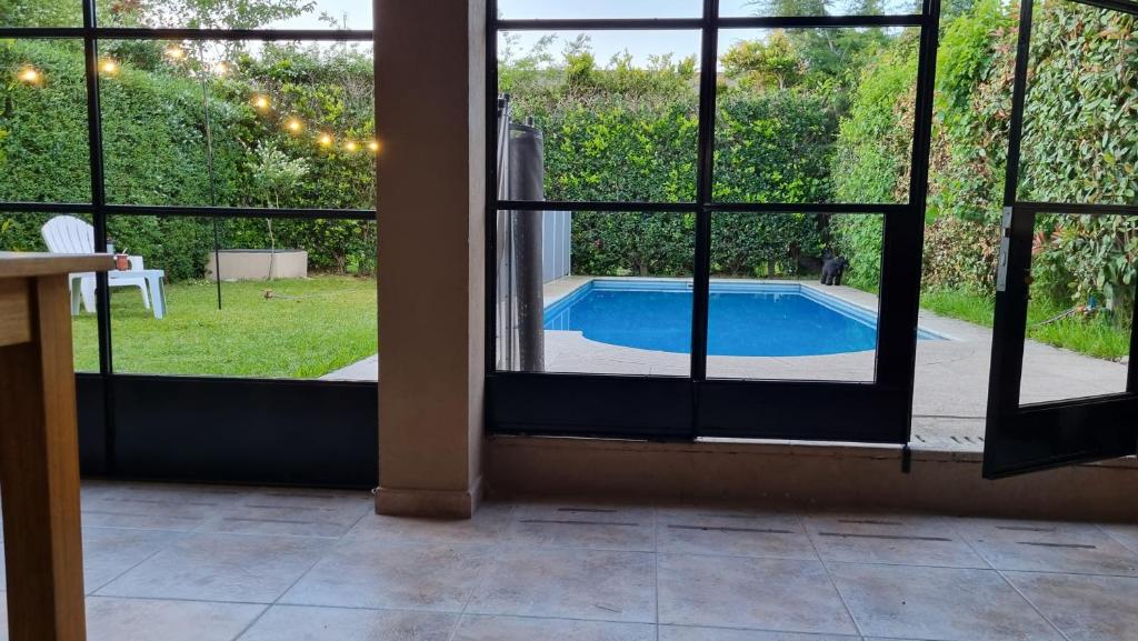 a view of a swimming pool through a window at Casa en barrio cerrado con seguridad 24 horas con piscina in Barrio Esteban Echeverría