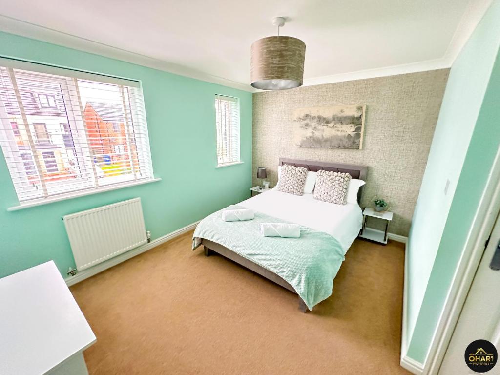 a bedroom with a bed and two windows at Modern 3 Bedroom House With FREE Parking in Kenton