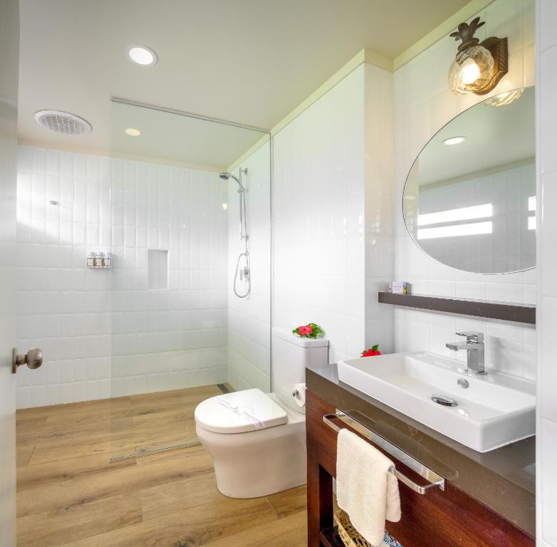 a bathroom with a sink and a toilet and a mirror at Fiji Gateway Hotel in Nadi