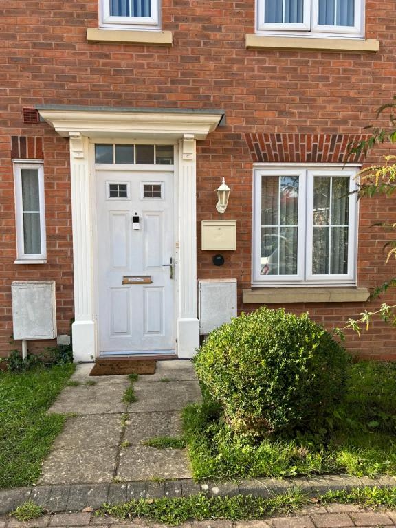 a white front door of a brick house at Maidstone, Birmingham, Uk in Birmingham