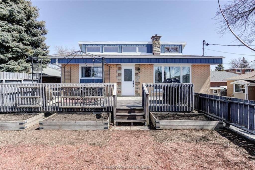 a house with a fence in front of it at Charming Nordic Style - 2BR + 1 Bath Entire House in Sudbury