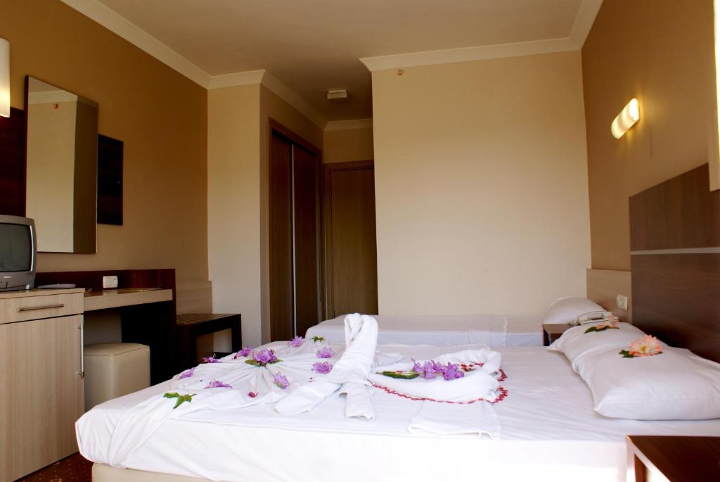 Postel nebo postele na pokoji v ubytování Magic Sun Hotel