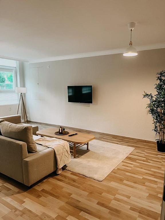 a living room with a couch and a table at Wohnen im 3 Ländereck! Essen, Mülheim, Oberhausen. BSEG in Essen