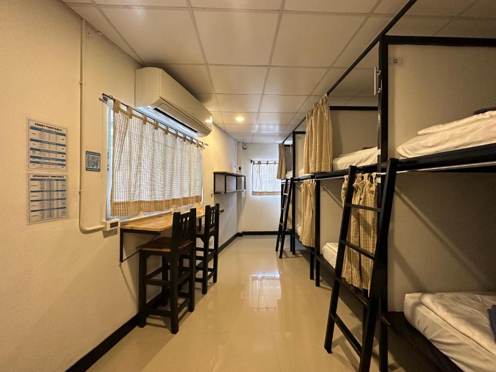 a hallway of a dorm room with bunk beds at Blue Flow Hostel in Phi Phi Islands
