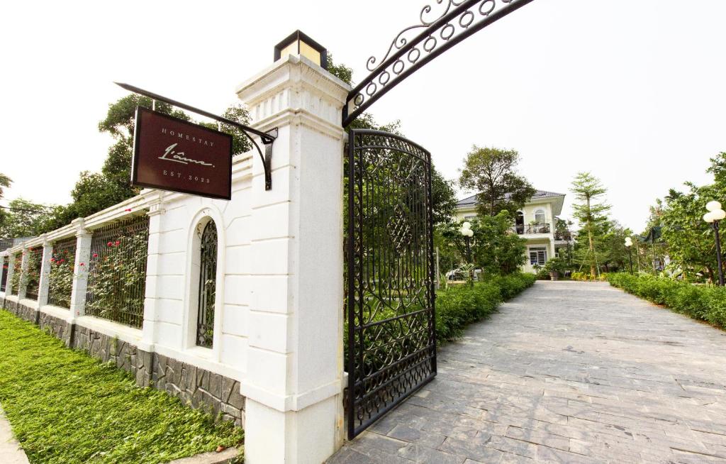 a gate at the end of a walkway at L'âme - The Hideaway in Thôn Dương Xuân Hạ