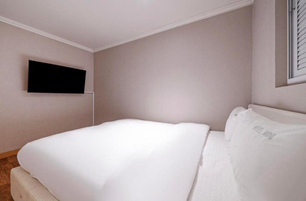 Postel nebo postele na pokoji v ubytování HOTEL mini