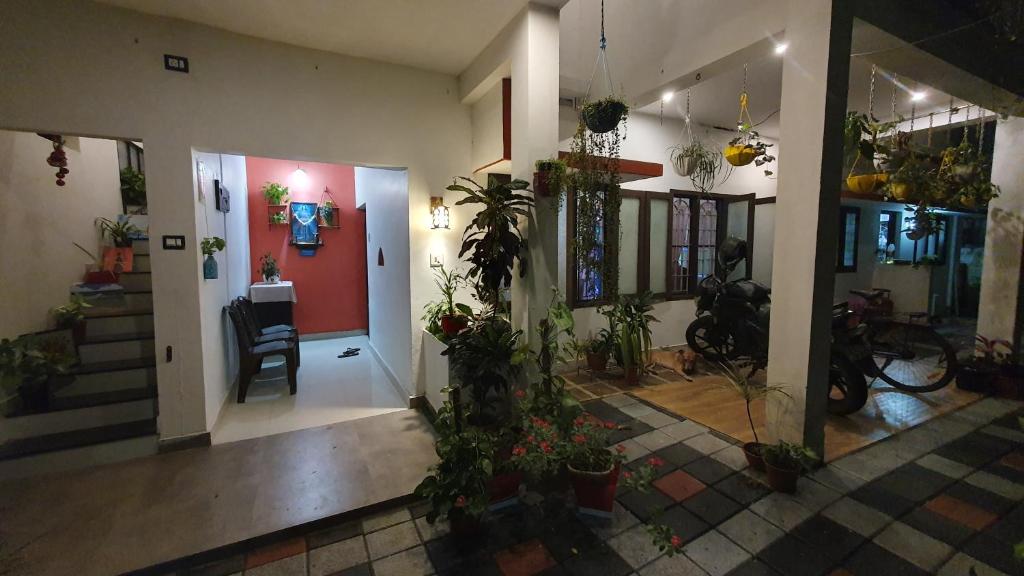 a hallway with potted plants in a house at Gerards Home stay Fortkochi in Cochin