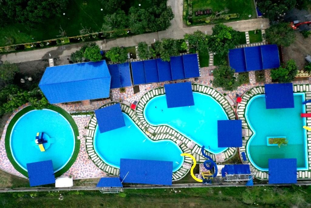 an overhead view of three pools with blue roofs at Blue Palm Mountain Resort in Midsayap