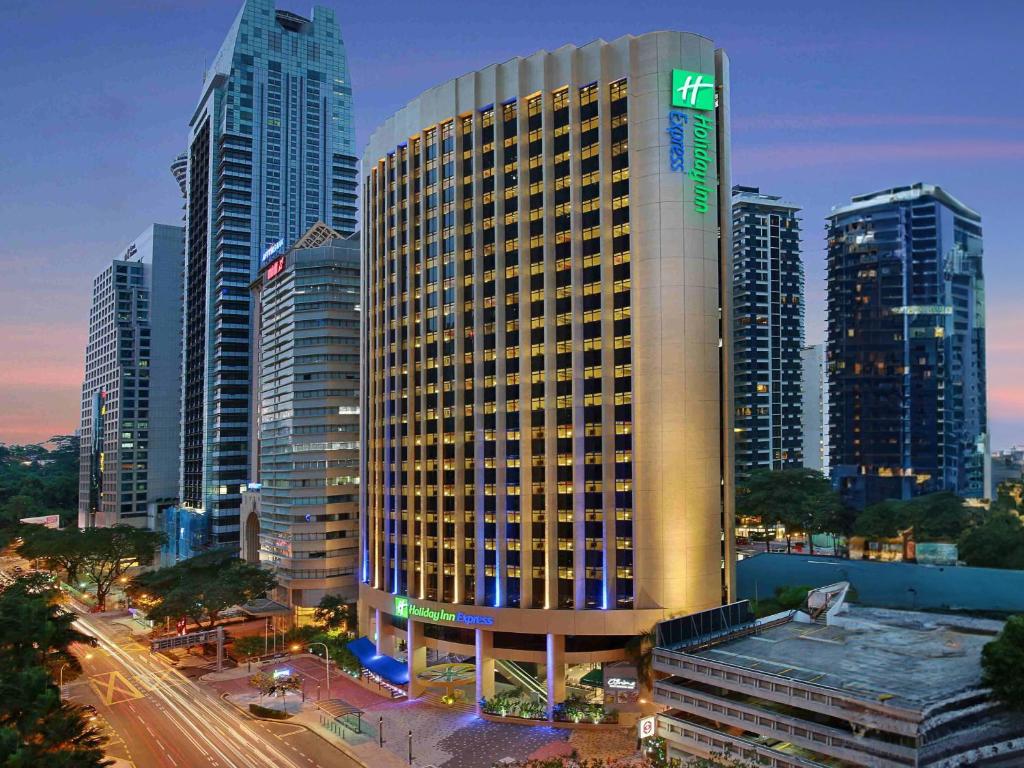 a large building in a city with tall buildings at Holiday Inn Express Kuala Lumpur City Centre, an IHG Hotel in Kuala Lumpur
