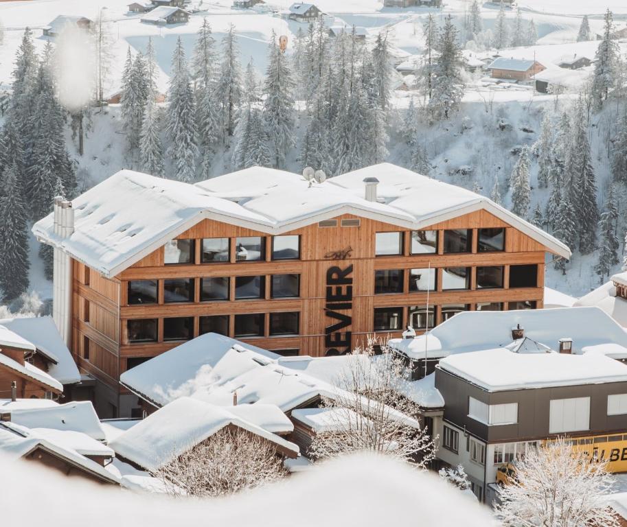 a lodge in the snow with snow covered roofs at Revier Mountain Lodge Adelboden in Adelboden
