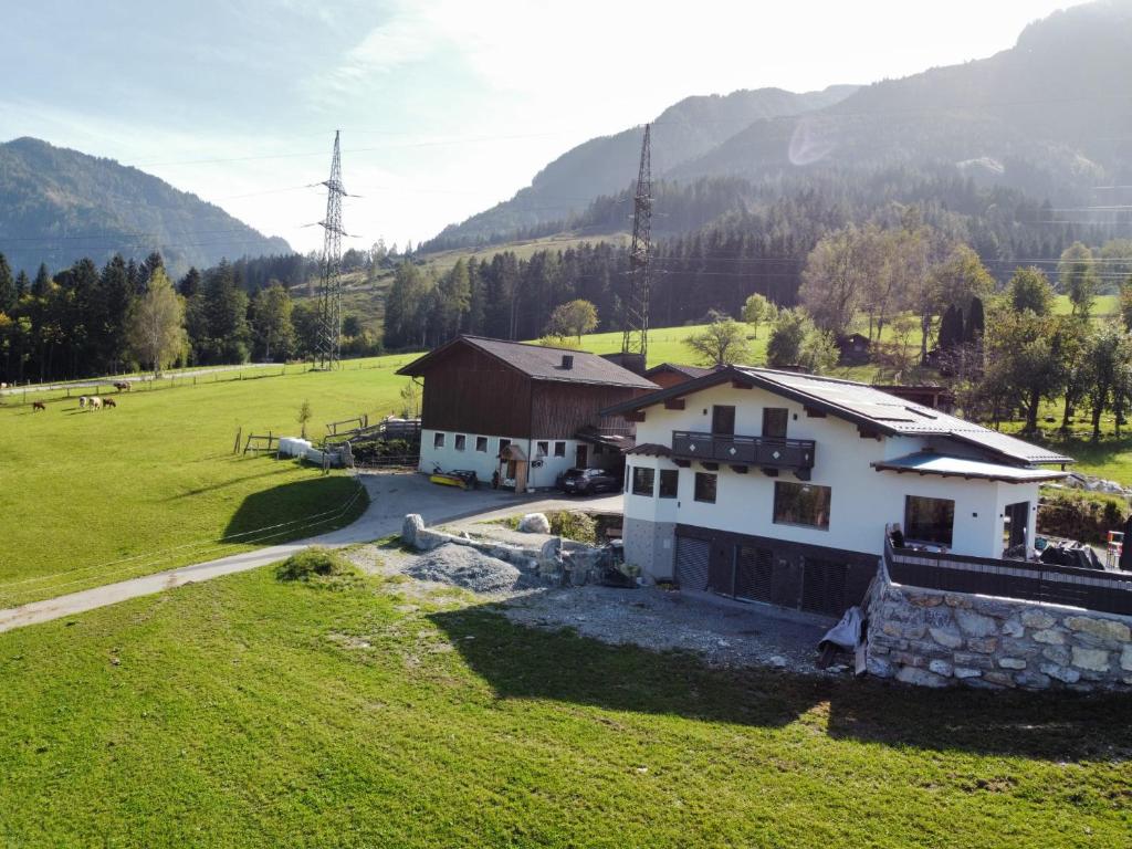 an aerial view of a house in a field at Bauernhof Sonnenhuab in Sankt Veit im Pongau