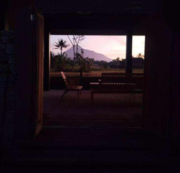 a room with a bench and a window with the sunset at Baku Living, brings Healty life in Ngaglik