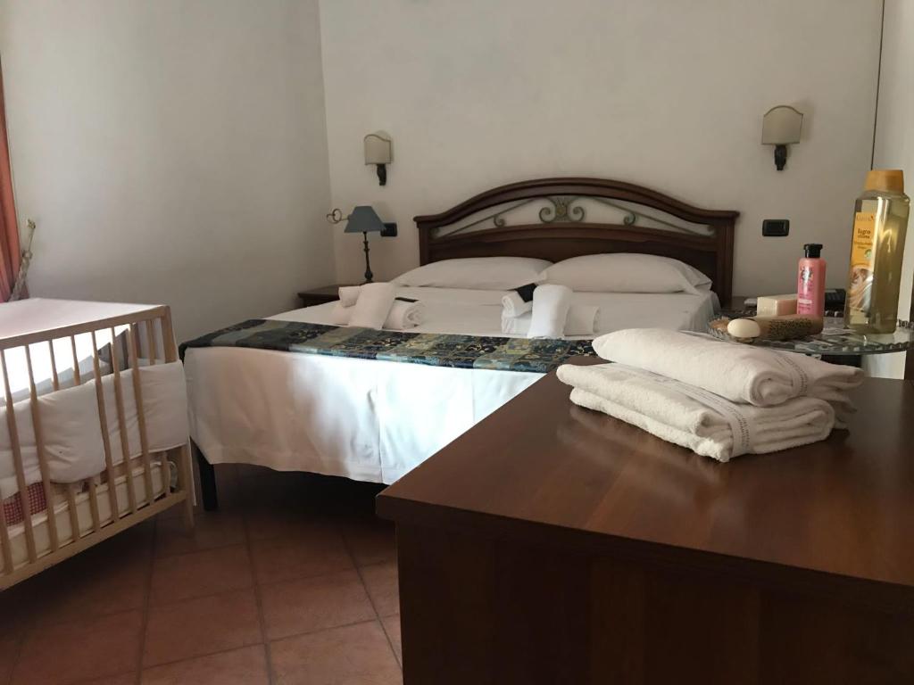 a bedroom with a bed with white sheets and pillows at EURO HOUSE INN airport in Fiumicino