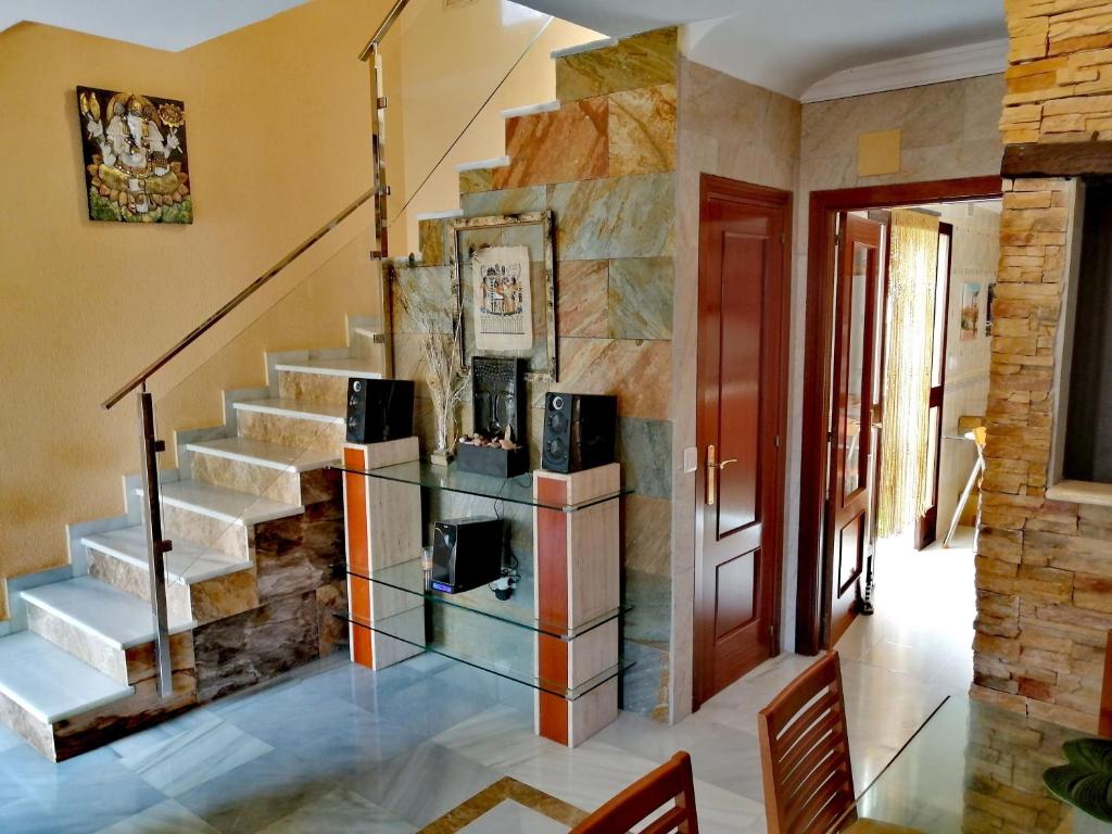 a staircase in a home with a stone wall at Mikalita in San Fernando