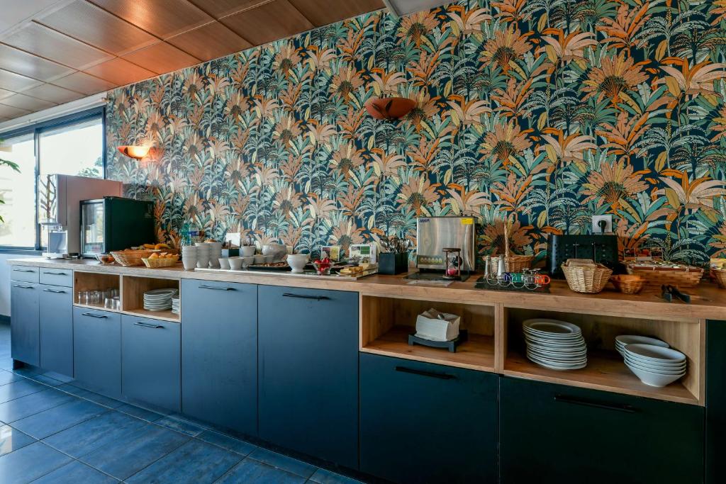 Kuchyň nebo kuchyňský kout v ubytování Hotel Le Pavillon Bleu