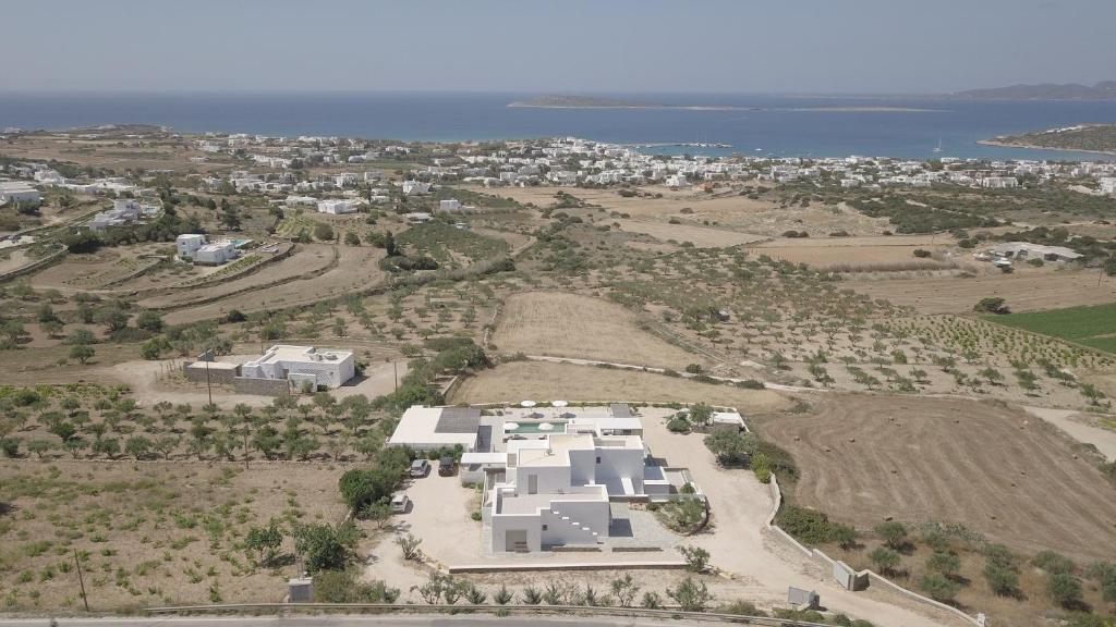 an aerial view of a white house in a field at Olive Garden Luxury Resort in Angairiá