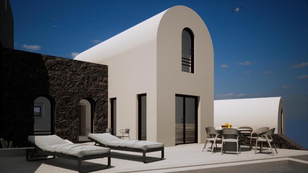 un patio con mesa y sillas y un edificio en Bay View Residences Santorini en Akrotiri