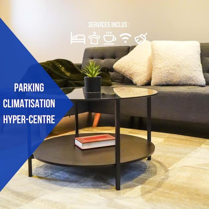 une table dans un salon avec un canapé dans l'établissement Le Rive Hugo • Élégance & Art de vivre, à Châteauroux