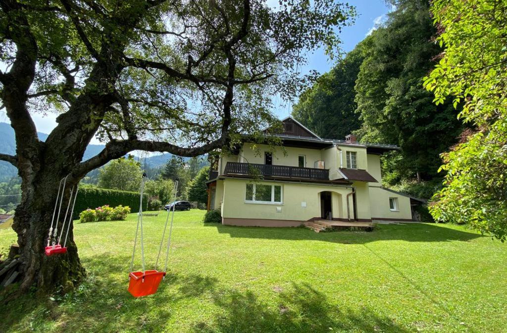 a house in a yard with a tree and a swing at local tax 3 Eur guest for night in Semmering