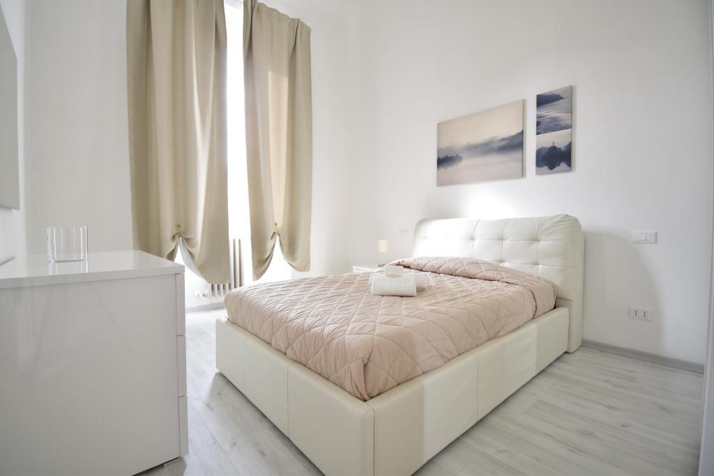 a white bedroom with a white bed in a room at Orsini Luxury Apartment in Florence