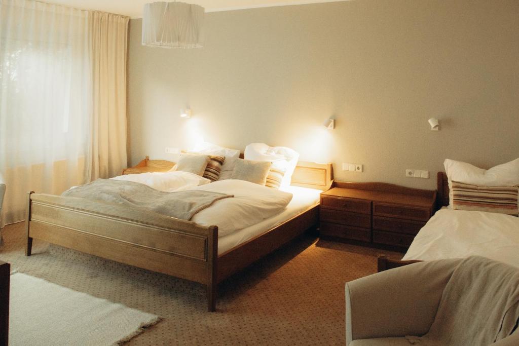 a hotel room with two beds and a chair at The Resting Place in Lemgo