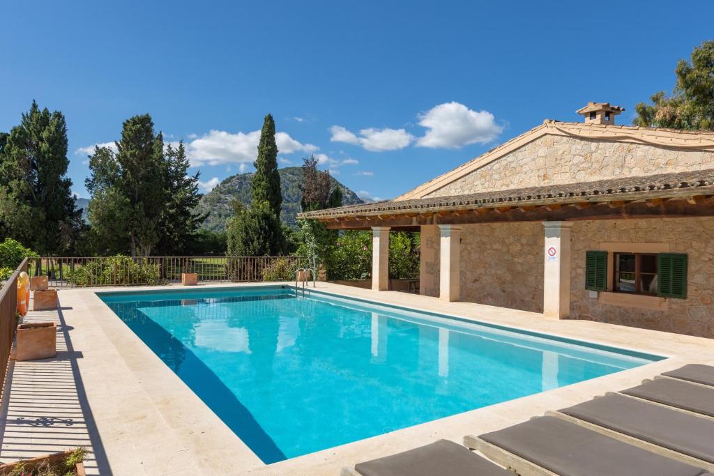 a swimming pool in a villa with a house at Buccara Casa Gran Daniel I in Pollença