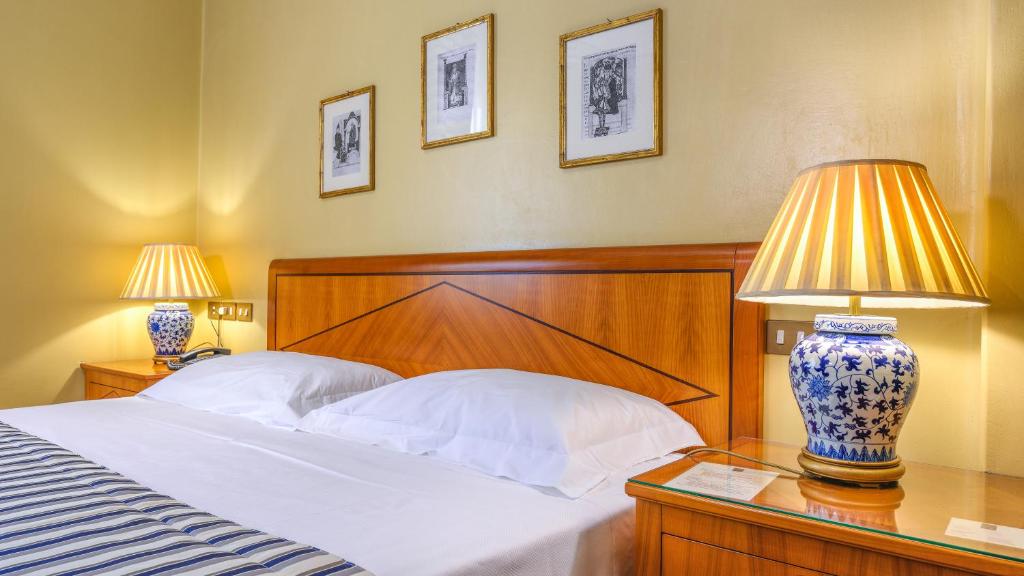 Postel nebo postele na pokoji v ubytování Albergo Reggio