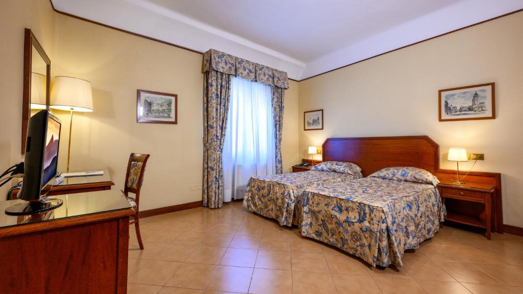 Postel nebo postele na pokoji v ubytování Albergo Reggio