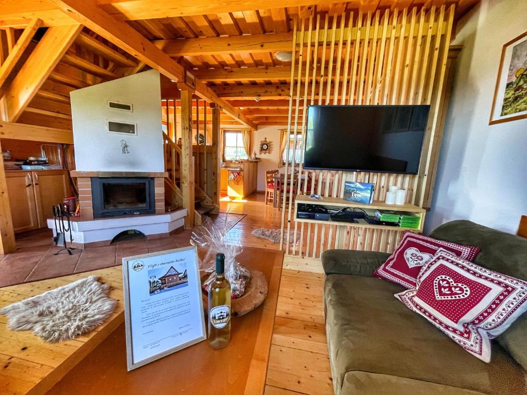 a living room with a couch and a fireplace at Drevenička Anička - Liptovská Mara in Liptovský Trnovec