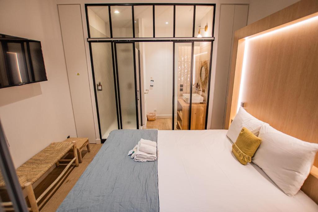 a bedroom with a large white bed and a window at LOLA Boutique Hôtel - Bordeaux Centre in Bordeaux