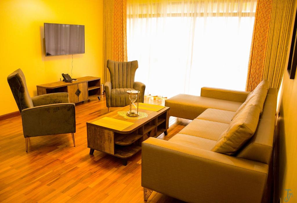 a living room with a couch and a table at TJ's Boutique Hotel in Eldoret