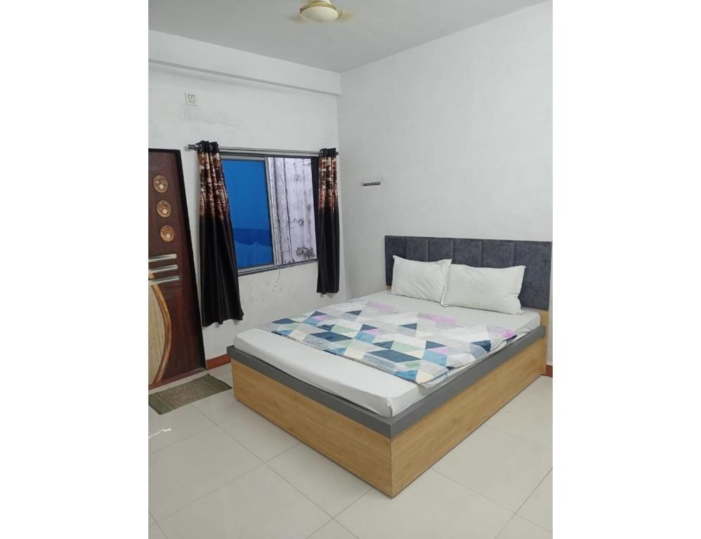 a bedroom with a bed in a room at Excel Hotel, Somnath in Somnath