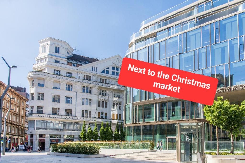 a red sign that reads next to the christmas market at Budapest Apartment in Budapest