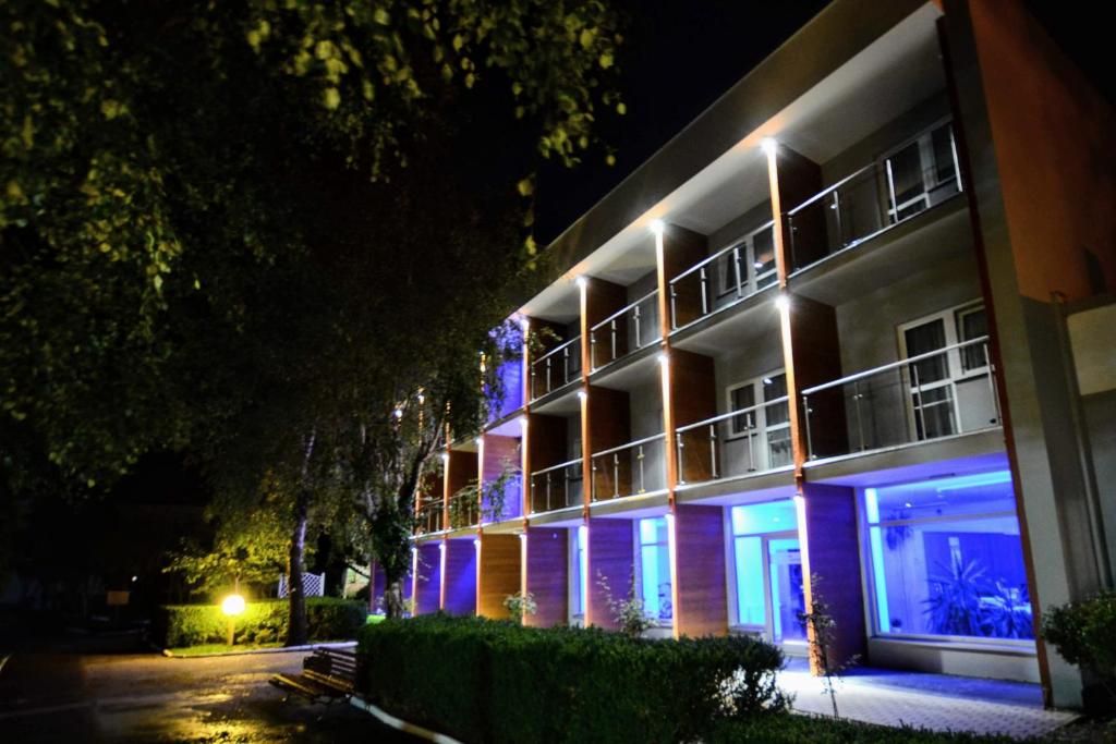a building with blue lights on the side of it at Ośrodek Wypoczynkowo-Leczniczy OPOLE w Dźwirzynie in Dźwirzyno