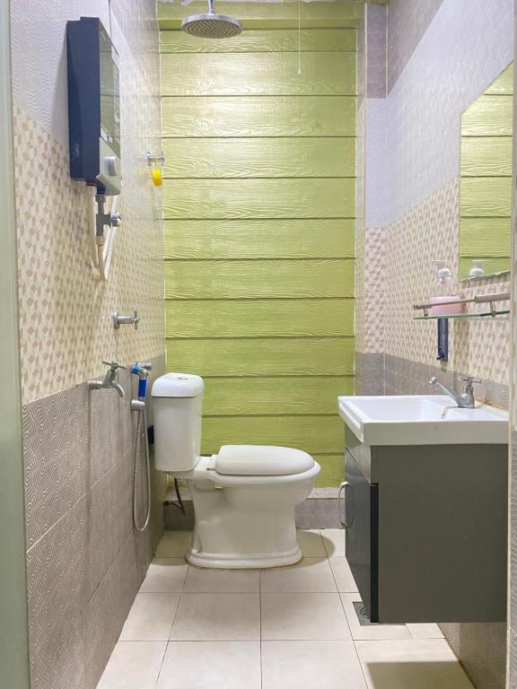 a bathroom with a toilet and a sink at Suza Hostel in Tumpat