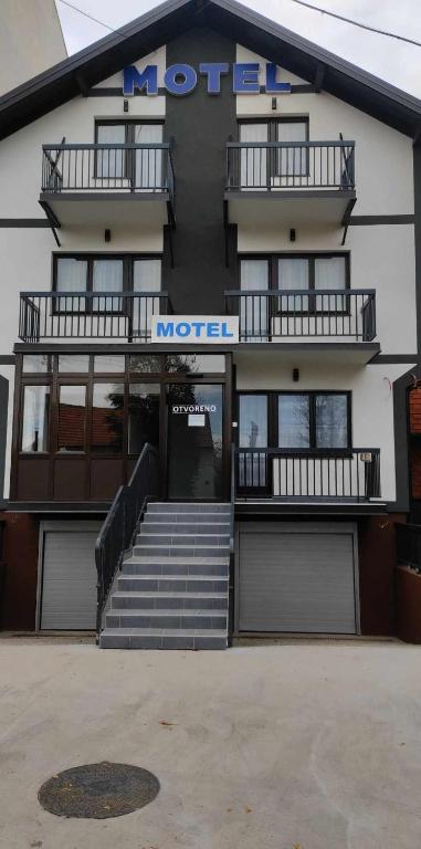 a hotel with stairs in front of a building at Motel BI in Bijeljina
