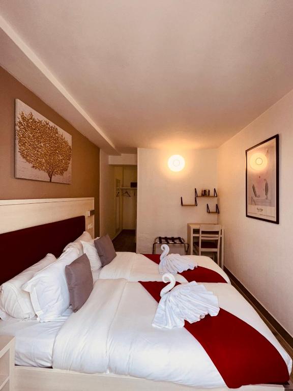 a bedroom with a large bed with towels on it at Pavillon Opéra Lafayette in Paris